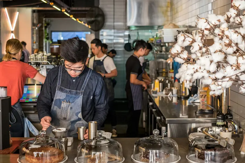 Staff behind a counter of fresh bakes.