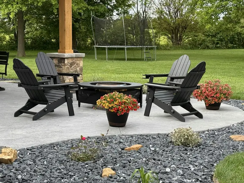 A paved patio with a fire pit.