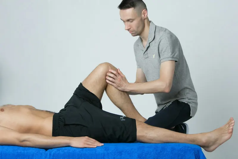 A physio assessing a knee.